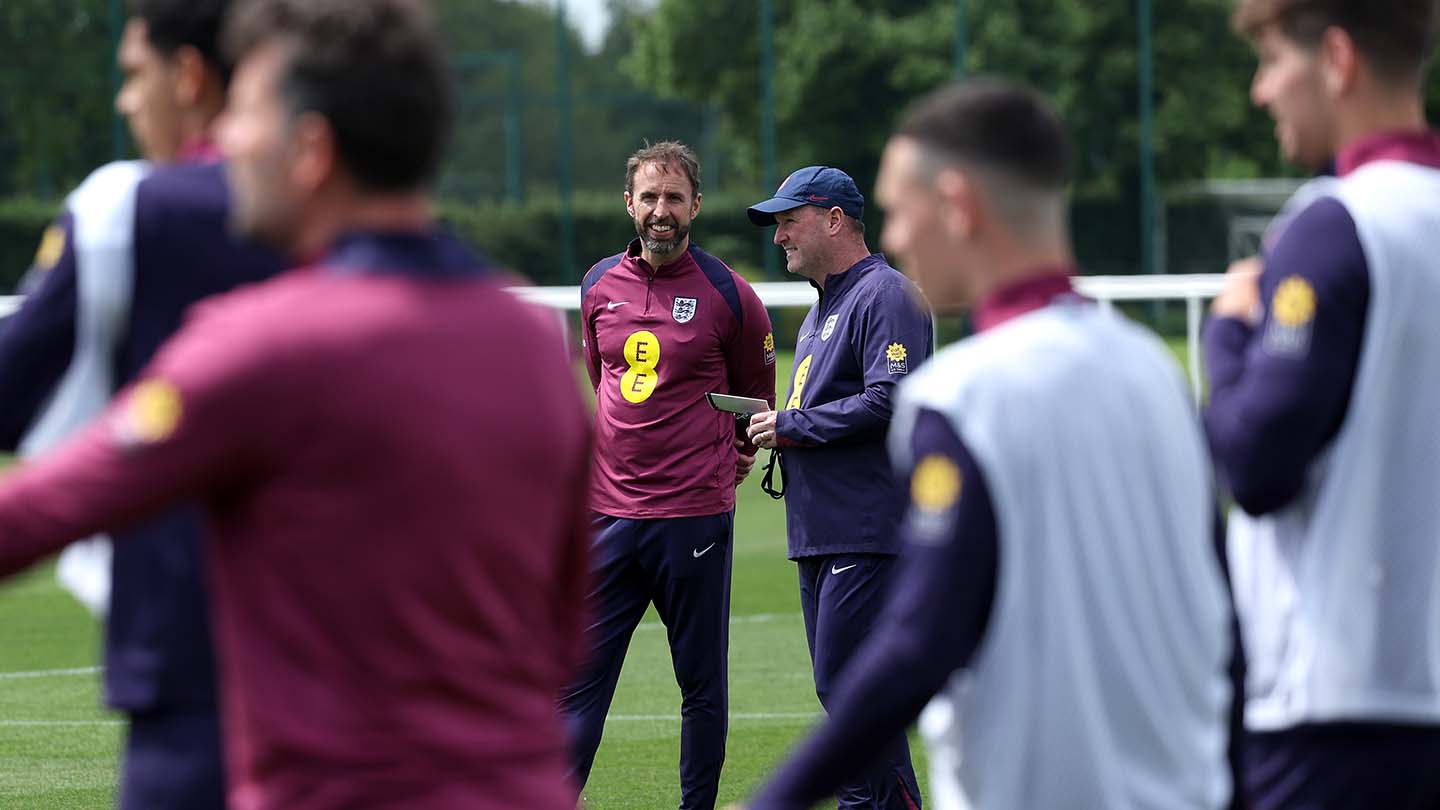Gareth Southgate, Manager of England men's senior team, and Steve Holland, Assistant Manager of England, look on during a training session at Tottenham Hotspur Training Centre
